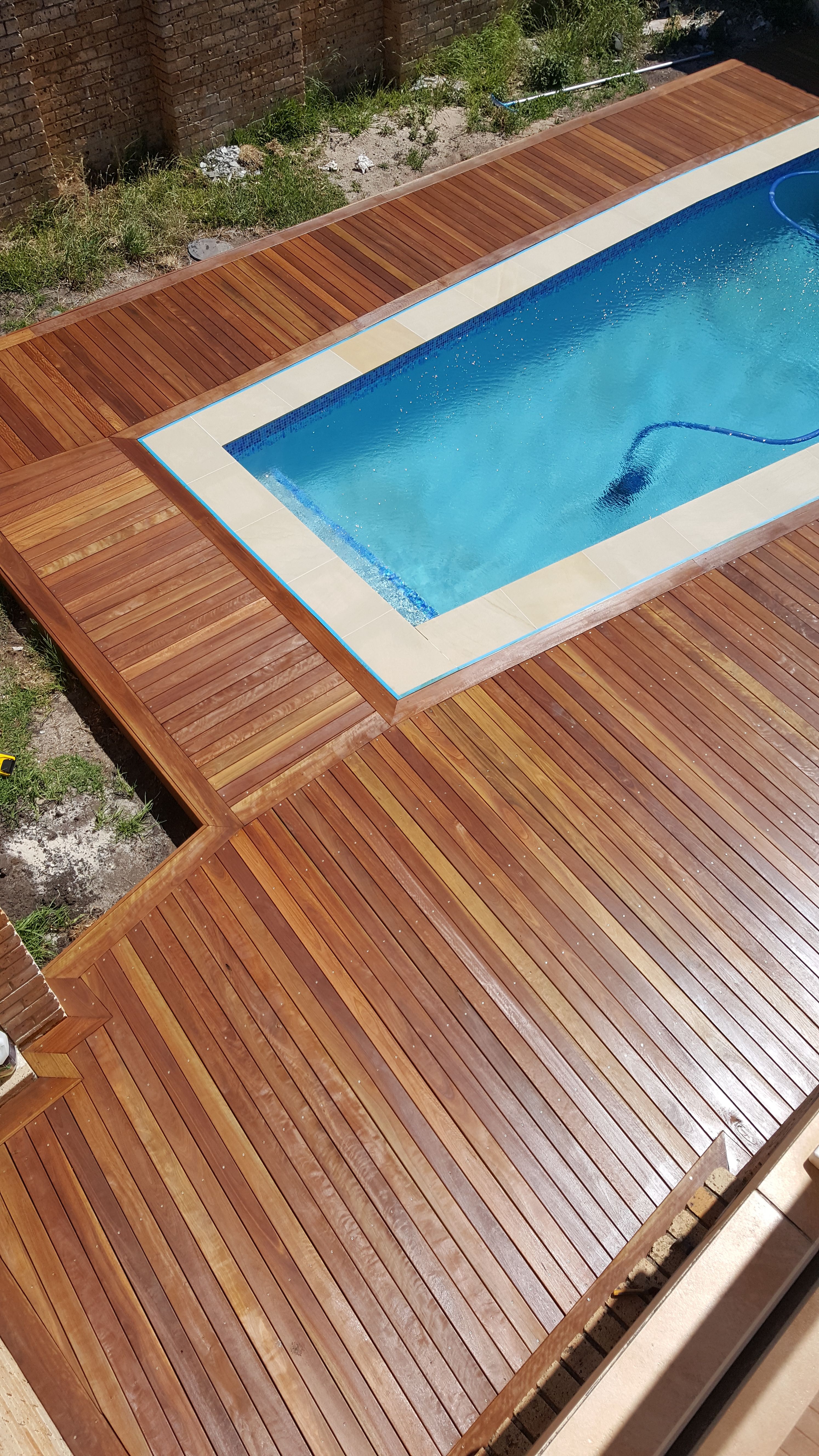 A recently constructed deck around a rectangular pool